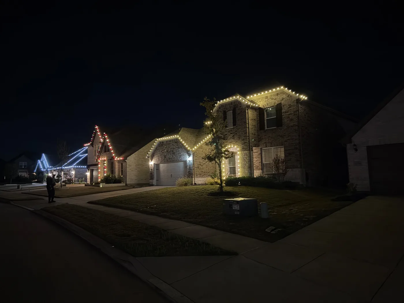 Several homes with holiday lighting