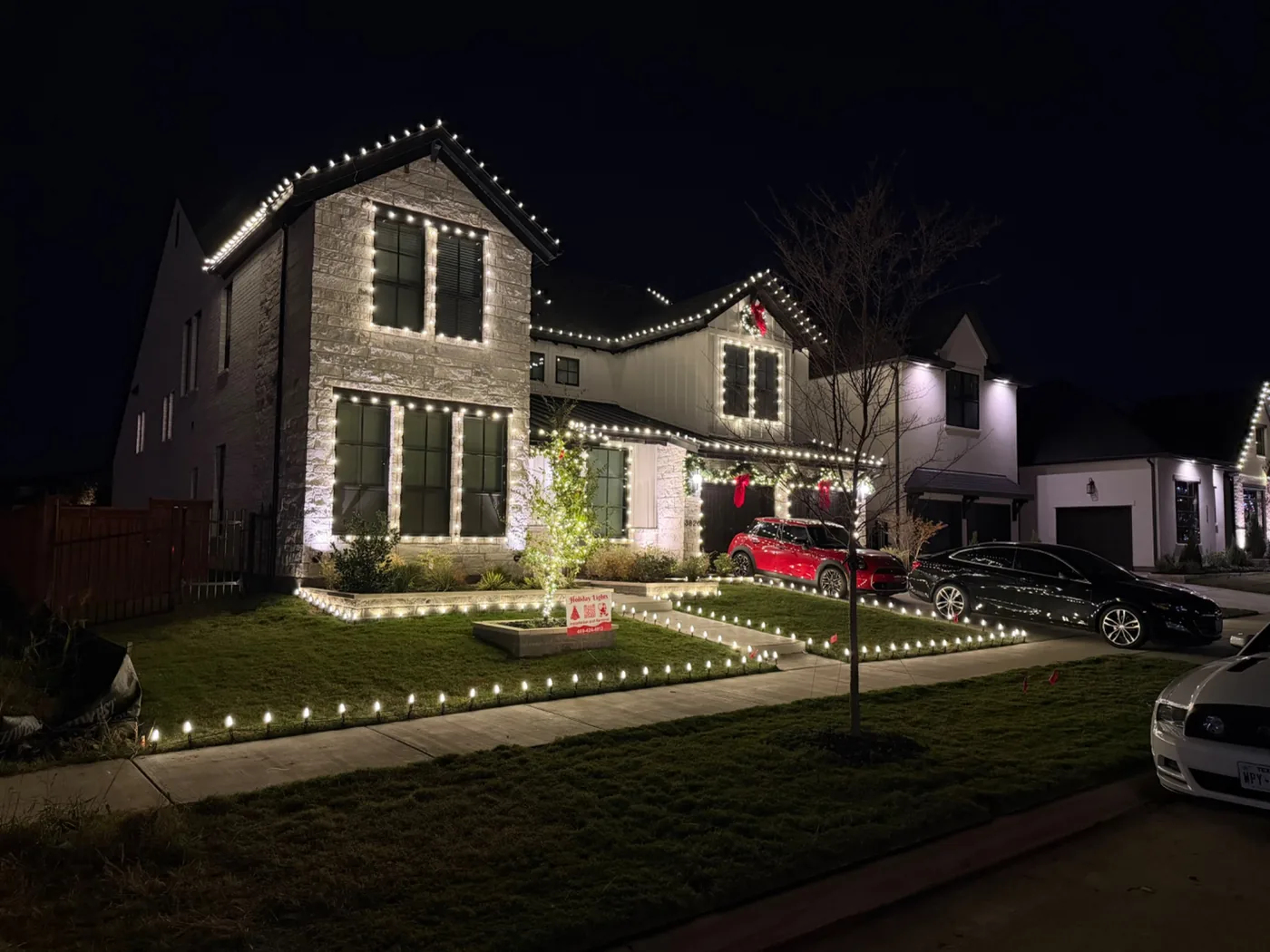 Warm white roofline and architectural holiday lighting